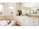 Beautiful bathroom with jacuzzi tub, natural light, and large vanity at 5184 Pinyon Jay Rd, Parker, CO 80134