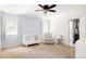 Well-lit bedroom with crib and comfortable chair near a bright window. Fresh and inviting space at 5184 Pinyon Jay Rd, Parker, CO 80134