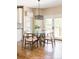 Cozy dining area features a glass table, modern light fixture, and access to the outdoor deck at 5184 Pinyon Jay Rd, Parker, CO 80134