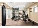 Home gym featuring heavy bag, squat rack, weights, and cardio equipment; perfect for staying fit without leaving home at 5184 Pinyon Jay Rd, Parker, CO 80134
