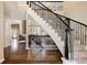 Inviting foyer with a grand staircase, hardwood floors, and views into the living room at 5184 Pinyon Jay Rd, Parker, CO 80134