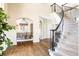 Elegant foyer showcasing staircase, hardwood floors, archways and views to the dining room at 5184 Pinyon Jay Rd, Parker, CO 80134