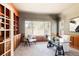 Bright office featuring custom wood built-ins, ample natural light and a glass desk at 5184 Pinyon Jay Rd, Parker, CO 80134
