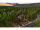 Aerial view of a beautiful home nestled in a lush forest with scenic mountain views at 7737 Taylor Cir, Larkspur, CO 80118