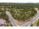 Aerial view of a home nestled in a tranquil, wooded community with winding roads at 7737 Taylor Cir, Larkspur, CO 80118