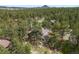 Aerial view of the home surrounded by lush green trees and mature landscaping at 7737 Taylor Cir, Larkspur, CO 80118