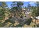 Large backyard with mature trees and fenced-in area, perfect for outdoor activities and privacy at 7737 Taylor Cir, Larkspur, CO 80118