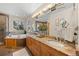 Bathroom featuring double sinks, granite counters, a soaking tub and tile floors at 7737 Taylor Cir, Larkspur, CO 80118
