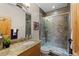 Bathroom featuring a single sink vanity, granite countertops, and tiled shower at 7737 Taylor Cir, Larkspur, CO 80118