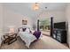 Cozy bedroom with vaulted ceiling, a sitting area by the window, and warm, inviting decor at 7737 Taylor Cir, Larkspur, CO 80118
