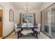 Elegant dining room with stylish seating, a chandelier, and a window overlooking the natural landscape at 7737 Taylor Cir, Larkspur, CO 80118