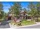 Beautiful two-story home with a three-car garage and a well-manicured lawn at 7737 Taylor Cir, Larkspur, CO 80118