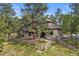 Back of the house featuring a fenced yard and natural landscaping at 7737 Taylor Cir, Larkspur, CO 80118