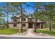 Charming two-story home with a stone accent, a covered porch, and professional landscaping at 7737 Taylor Cir, Larkspur, CO 80118