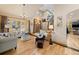 Grand foyer featuring a staircase, elegant lighting, and views into the inviting living spaces at 7737 Taylor Cir, Larkspur, CO 80118