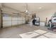 Spacious garage with glass panel door, epoxy floor, and ample storage for a functional workspace at 7737 Taylor Cir, Larkspur, CO 80118