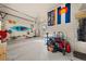 Clean garage featuring Colorado sports flags, storage cabinets, and a convenient utility sink at 7737 Taylor Cir, Larkspur, CO 80118
