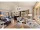 Bright living area with hardwood floors, comfortable sofas, and large windows with views of the outdoors at 7737 Taylor Cir, Larkspur, CO 80118