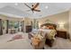Expansive primary bedroom showcasing a tray ceiling, large windows, and neutral decor at 7737 Taylor Cir, Larkspur, CO 80118