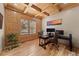 Home office features wood paneling, coffered ceiling, and ample natural light at 7737 Taylor Cir, Larkspur, CO 80118