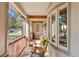Inviting porch with wood flooring, rocking chairs, and stone accents, perfect for relaxation and enjoying the outdoors at 7737 Taylor Cir, Larkspur, CO 80118