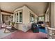 Inviting porch with outdoor seating, stone accents, and a tranquil view of surrounding trees at 7737 Taylor Cir, Larkspur, CO 80118