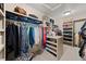 Spacious walk-in closet with ample shelving and hanging storage for organization at 7737 Taylor Cir, Larkspur, CO 80118