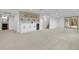 Finished basement featuring a wet bar, mini fridge, neutral carpet and a walkout to the backyard at 2961 S Rosemary St, Denver, CO 80231