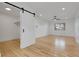 Bright bedroom with modern sliding door, hardwood floors, and contemporary ceiling fan at 2961 S Rosemary St, Denver, CO 80231
