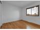 Neutral bedroom with beautiful hardwood floors, a window, and crisp white walls at 2961 S Rosemary St, Denver, CO 80231
