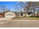 Charming single-story home with a well-manicured lawn, inviting curb appeal, and attached garage at 2961 S Rosemary St, Denver, CO 80231