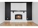 Inviting fireplace with black accents and white brick providing a cozy atmosphere at 2961 S Rosemary St, Denver, CO 80231
