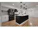 Modern kitchen features an island, stylish black and gold appliances, and sleek countertops at 2961 S Rosemary St, Denver, CO 80231