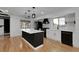Well-lit kitchen boasts a functional island, modern appliances, and views from the window at 2961 S Rosemary St, Denver, CO 80231