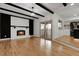 Spacious living area featuring a fireplace, hardwood floors, and sliding door access to the outdoors at 2961 S Rosemary St, Denver, CO 80231
