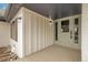 Covered front porch with modern lighting fixtures and ample space for welcoming guests at 2961 S Rosemary St, Denver, CO 80231