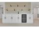 Close up of the basement wet bar featuring a mini fridge, a sink, and floating shelves at 2961 S Rosemary St, Denver, CO 80231