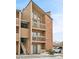 Tan and brick multi-level condo building with stairs and balconies at 12366 W Nevada Pl # 308, Lakewood, CO 80228