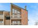 Close-up of condo building, highlighting the brick and wood siding at 12366 W Nevada Pl # 308, Lakewood, CO 80228