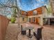 A backyard with a small patio set on a stone base, and brick patio leading up to the house at 240 Colorado Blvd, Denver, CO 80206