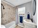 The bathroom is adorned with textured tile, vintage fixtures and ample counter space at 240 Colorado Blvd, Denver, CO 80206