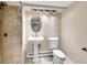 The bathroom is adorned with textured tile, vintage fixtures and standing sink at 240 Colorado Blvd, Denver, CO 80206
