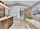 Well-appointed bathroom featuring a double vanity, soaking tub, and a glass-enclosed shower at 240 Colorado Blvd, Denver, CO 80206