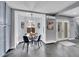 Bright breakfast nook features a glass table, modern lighting, and backyard views at 240 Colorado Blvd, Denver, CO 80206