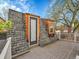 A wood deck with a door and window facing outside, surrounded by trees and a white railing at 240 Colorado Blvd, Denver, CO 80206