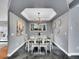 Formal dining room with modern chandelier, neutral paint, slate floors, and sleek decor at 240 Colorado Blvd, Denver, CO 80206
