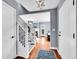 Entryway with hardwood floors, staircase, white trim, and stylish light fixtures at 240 Colorado Blvd, Denver, CO 80206