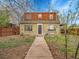 Exterior shot of a home, featuring a front yard, walkway, and a quaint porch at 240 Colorado Blvd, Denver, CO 80206