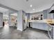 Spacious kitchen featuring stainless steel appliances, slate floors, and light blue cabinetry at 240 Colorado Blvd, Denver, CO 80206