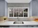 Kitchen features a modern sink, stylish brick backsplash, and ample cabinet space at 240 Colorado Blvd, Denver, CO 80206